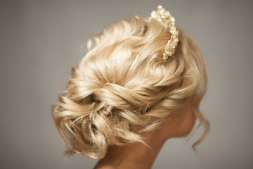 Beautiful blond girl in the image of a bride with a tiara in her hair. Picture taken in the studio...