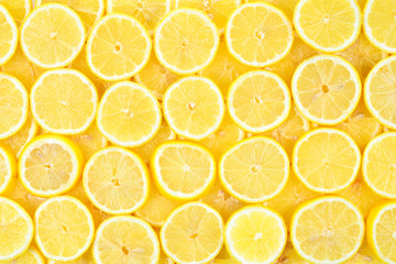A slices of fresh juicy yellow lemons.  Texture background, pattern.