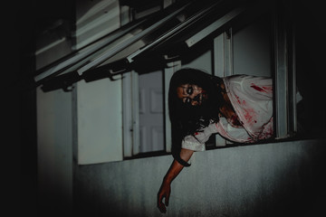 Portrait of asian woman make up ghost face with blood,Horror scene,Scary background,Halloween...