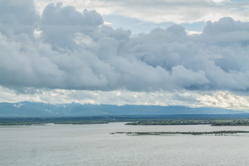 Landscape of water reservoir and big dark clouds in rainy season. Ecology, natural environment and water irrigation management concept.