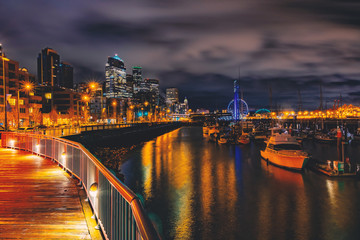 Seattle waterfront at night light,waterfront and skyline night light with a marina and ferris city background,Seattle pier-66 waterfront view with urban architecture at night