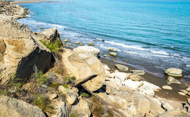 Seashore, wild beach with protruding rocks