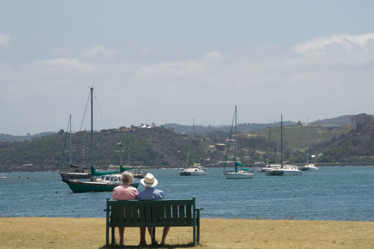 A Older Couple Sit On Border Coast Seeng The Sea