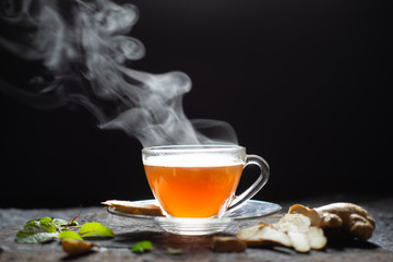 Hot Ginger tea in a glass on wood background.Hot drink . Copy space.