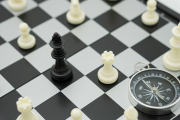 chessboard with a chess piece on the back Negotiating in business and compass. as background business concept and strategy concept with copy space.