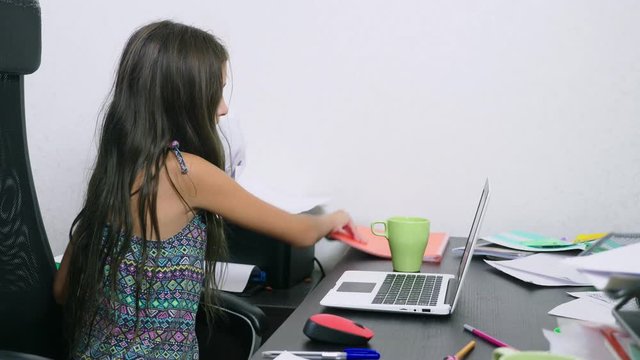 the girl poured tea on the laptop. doing homework, online learning, 4k close-ups,