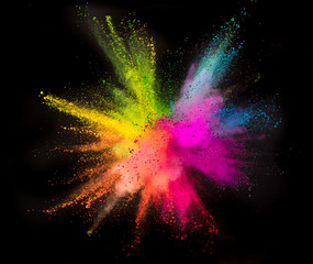 Colored powder explosion on black background.