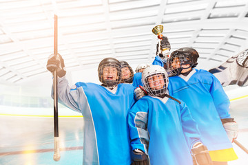 Fototapeta premium Ice hockey team holding trophy above their heads