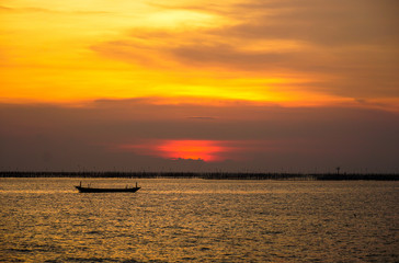 Small fishing boat with sunset light