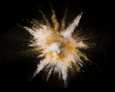 Silver And Gold Powder Explosion On Black Background.