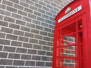 London phone booth with brick background