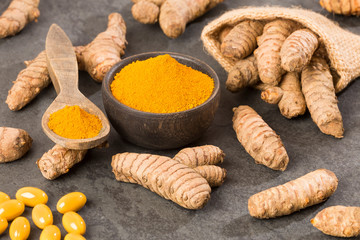 Roots, powder and turmeric pills - Curcuma longa. Space for text