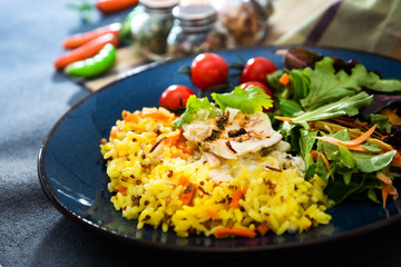 Cooked rice with vegetables, cod and lemon sauce