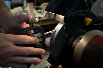 man sharpening chisel 