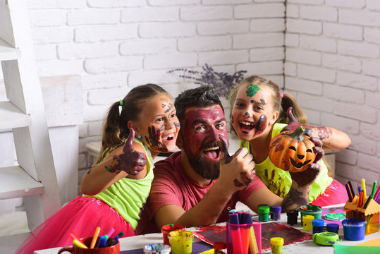 Halloween children with happy face in paint.