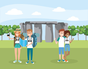 women and men friends with backpack in the stonehenge