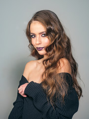 Fototapeta premium Beauty salon and hairdresser. Makeup cosmetics and skincare. woman with fashion makeup and long curly hair. Fashion portrait of woman. fashion girl with glamour makeup. Glamour fashion model