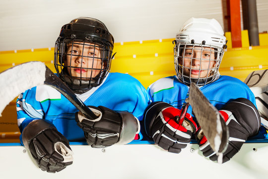 Boys in protective equipment at ice hockey stadium