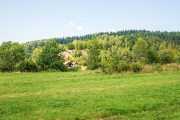 Summer landscape with field and hills in Central Europe.