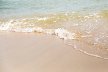 Bubbles of sea waves on the beach with sand.Sea breeze blowing waves to the beach.There are feeling fresh and succulent for this image.Can use for add text and abstract background. 