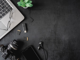 top view office table concept with coffee cup, digital camera, notebook, glasses, laptop and...