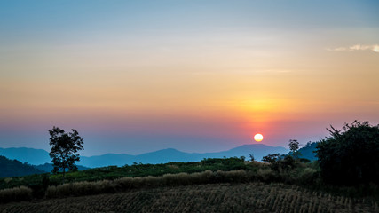 The sun rises over the mountains in the morning at Pu Teui national park ,Thailand.