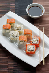 Traditional japanese seafood, roll and chopstick. Soy souce.