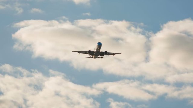 Telephoto shot of a large airliner approaching the airport moments before landing on a bright sunny day