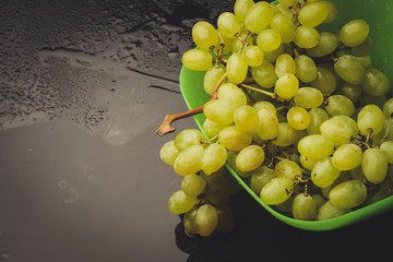 bunch of grapes in a plate on a dark background