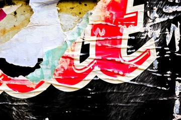 Old grunge ripped torn vintage collage posters creased crumpled paper surface placard texture background backdrop empty space for text letter	