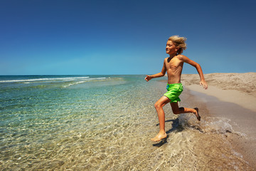 Young boy preparing to jump into the sea