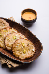 Malpua sweet - Traditional Indian dessert or pancake for festivals, served in plate with rabri/rabdi . selective focus