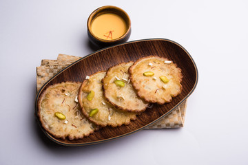Malpua sweet - Traditional Indian dessert or pancake for festivals, served in plate with rabri/rabdi . selective focus