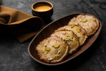 Malpua sweet - Traditional Indian dessert or pancake for festivals, served in plate with rabri/rabdi . selective focus