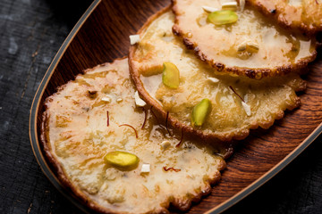 Malpua sweet - Traditional Indian dessert or pancake for festivals, served in plate with rabri/rabdi . selective focus