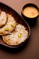 Malpua sweet - Traditional Indian dessert or pancake for festivals, served in plate with rabri/rabdi . selective focus