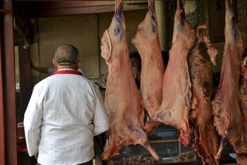 Butcher at Sunday Bazaar in Kashgar, Kashi, Xinjiang, China