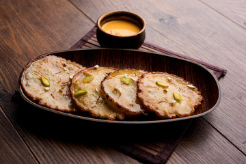 Malpua sweet - Traditional Indian dessert or pancake for festivals, served in plate with rabri/rabdi . selective focus