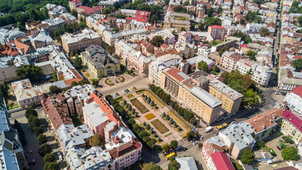 Fototapeta premium Top view of Chernivtsi city from above Western Ukraine. Theatre and Theatre square of Chernivtsi on sunset view.