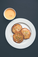Malpua sweet - Traditional Indian dessert or pancake for festivals, served in plate with rabri/rabdi . selective focus