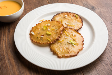 Malpua sweet - Traditional Indian dessert or pancake for festivals, served in plate with rabri/rabdi . selective focus