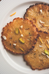 Malpua sweet - Traditional Indian dessert or pancake for festivals, served in plate with rabri/rabdi . selective focus