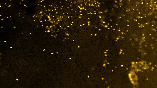 Floating gold nuggets and black dust particles on a nebulous background - full hd