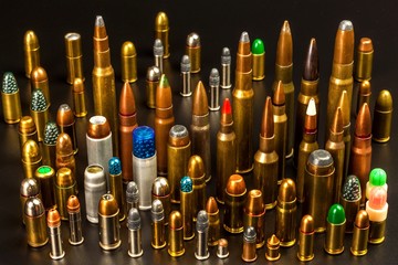 Different types of ammunition on a black background. Sale of weapons and ammunition. The right to hold a gun.