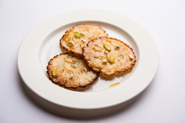 Malpua sweet - Traditional Indian dessert or pancake for festivals, served in plate with rabri/rabdi . selective focus