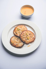 Malpua sweet - Traditional Indian dessert or pancake for festivals, served in plate with rabri/rabdi . selective focus