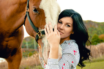 A Woman with her horse at sunset, autumn outdoors scene