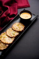 Malpua sweet - Traditional Indian dessert or pancake for festivals, served in plate with rabri/rabdi . selective focus