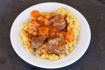 Veal in red sauce and rice with turmeric