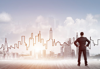 Motivation and inspiration concept with modern cityscape and businessman observing it